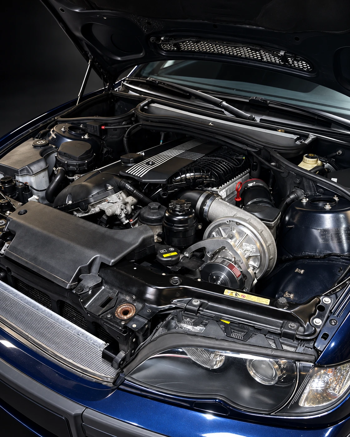 BMW E46 engine bay with an installed T21 ASA supercharger system on the M54 straight-six